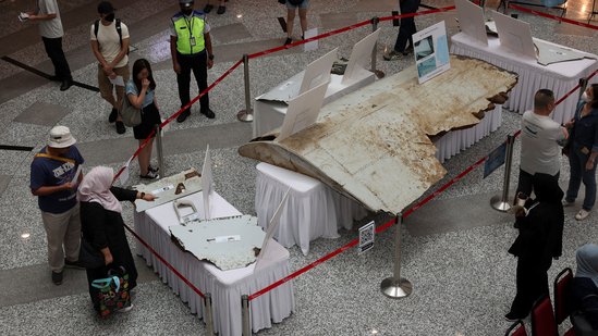 Visitors looking at the wreckage of an aircraft, believed to be from the missing Malaysia Airlines flight MH370, during the 10th anniversary event of its disappearance.(File Image/Reuters)