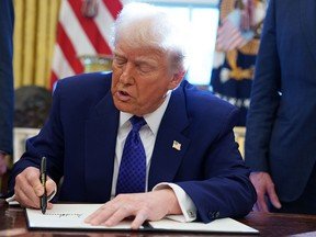 U.S. President Donald Trump signs an executive order in the Oval Office in Washington.