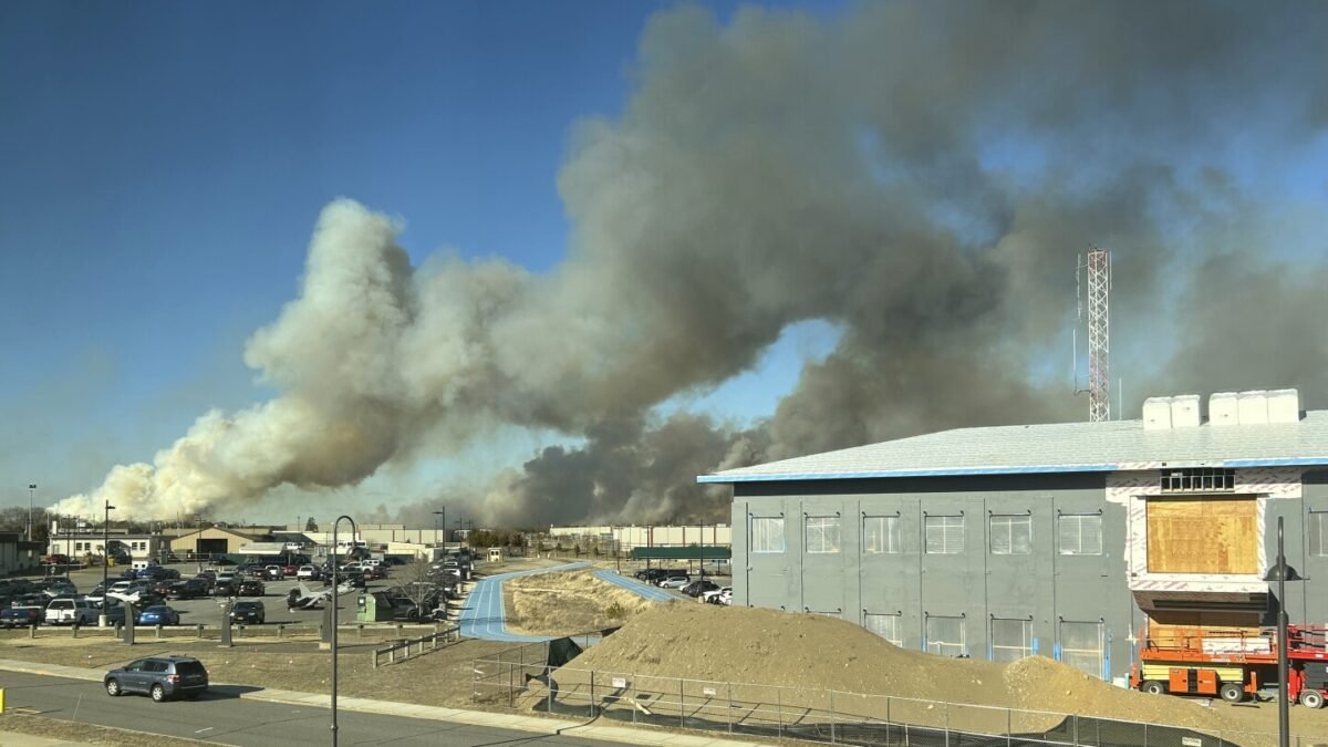 Wind-driven brush fire on New York's Long Island 50 percent contained. Firefighter injured