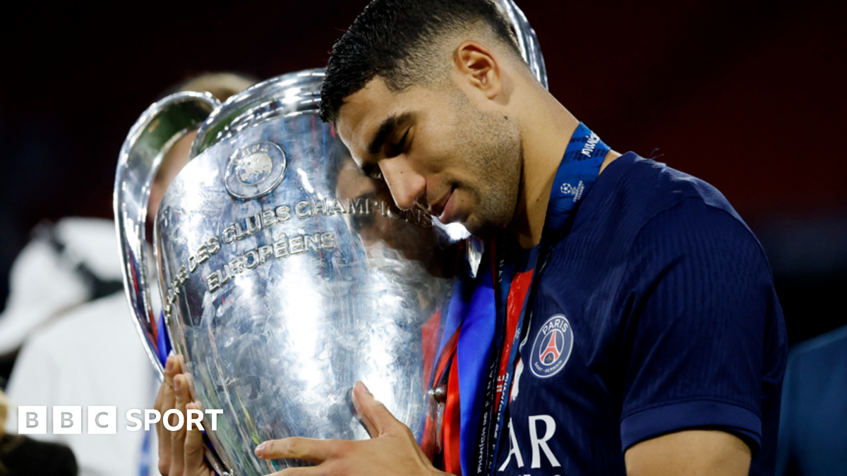 Paris St-Germain's Achraf Hakimi hugs the Champions League trophy after his side's 5-0 win over Inter Milan in the 2025 final in Munich