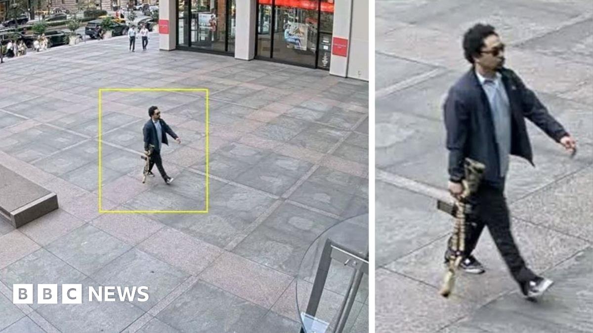 The suspect is seen on surveillance video entering the building with a rifle in his hand.